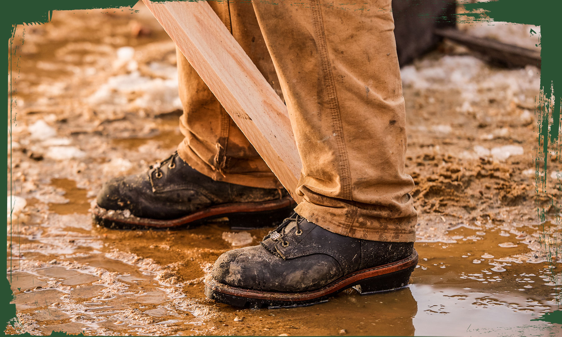 The Super Dna 9" Waterproof Steel Toe Insulated Logger in Black Oiled lying on a bed of river stone.