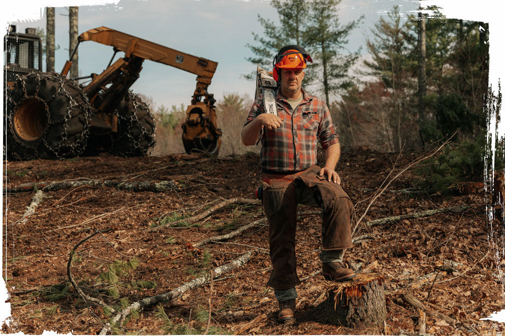 A logger wearing the Super Logger 9" Waterproof Insulated Steel Toe in aged bark (brown).