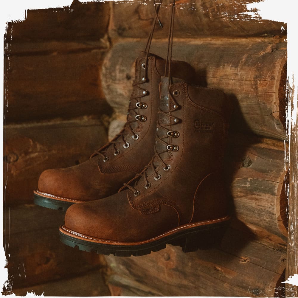 The Thunderstruck 9" Insulated Waterproof Nano Comp Toe Logger in walnut (brown) hanging up in a log cabin.