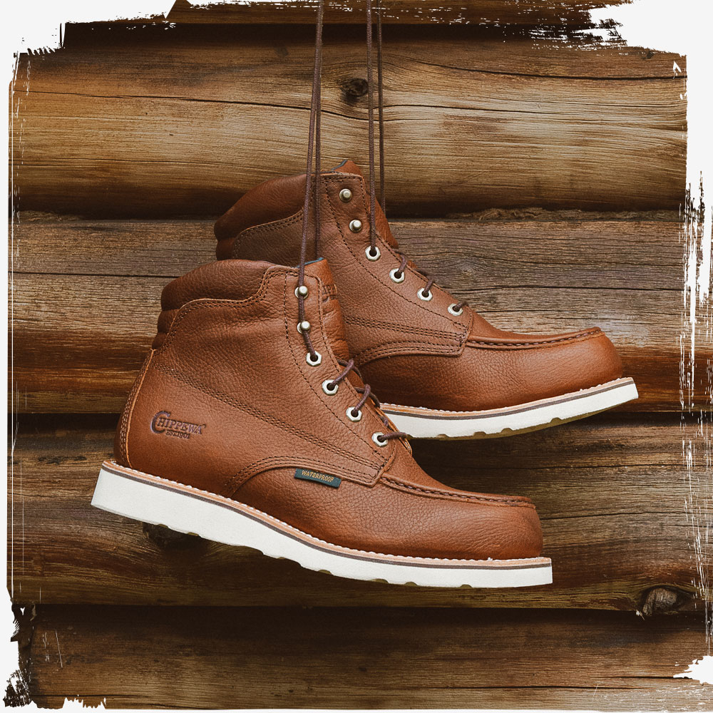The Edge Walker 6" Waterproof Lace Up Wedge in Briar Haystack (brown) hanging by its laces.