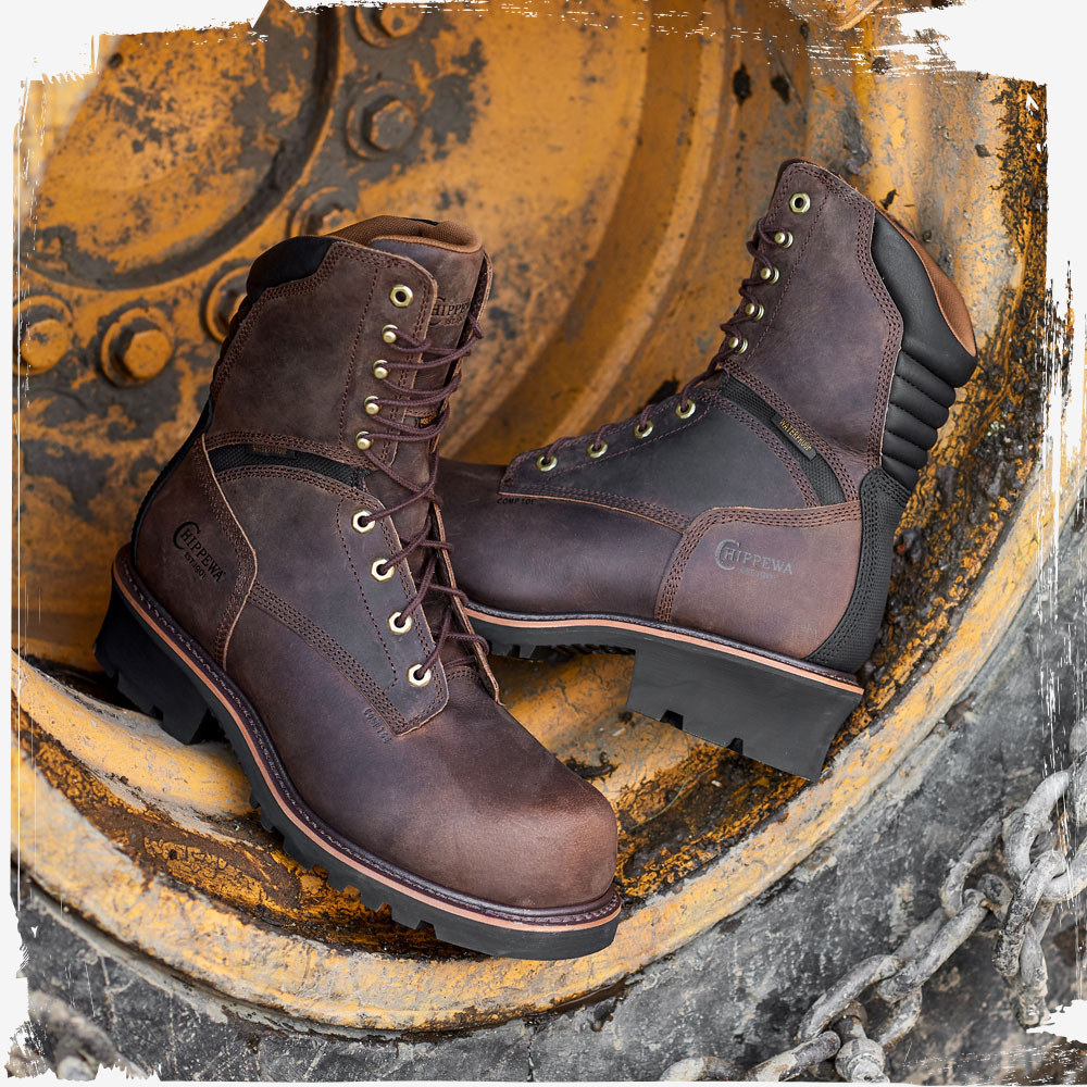 The Sador 9" Waterproof Insulated Comp Toe Logger in buff crazy horse (brown) in a tire of a tractor.