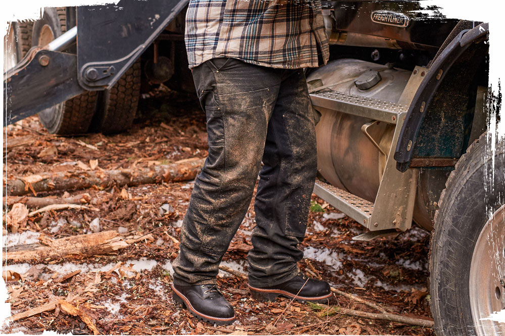 A man wearing the Super Dna 9" Waterproof Insulated Steel Toe Logger in Black Oiled while working on a logging site.