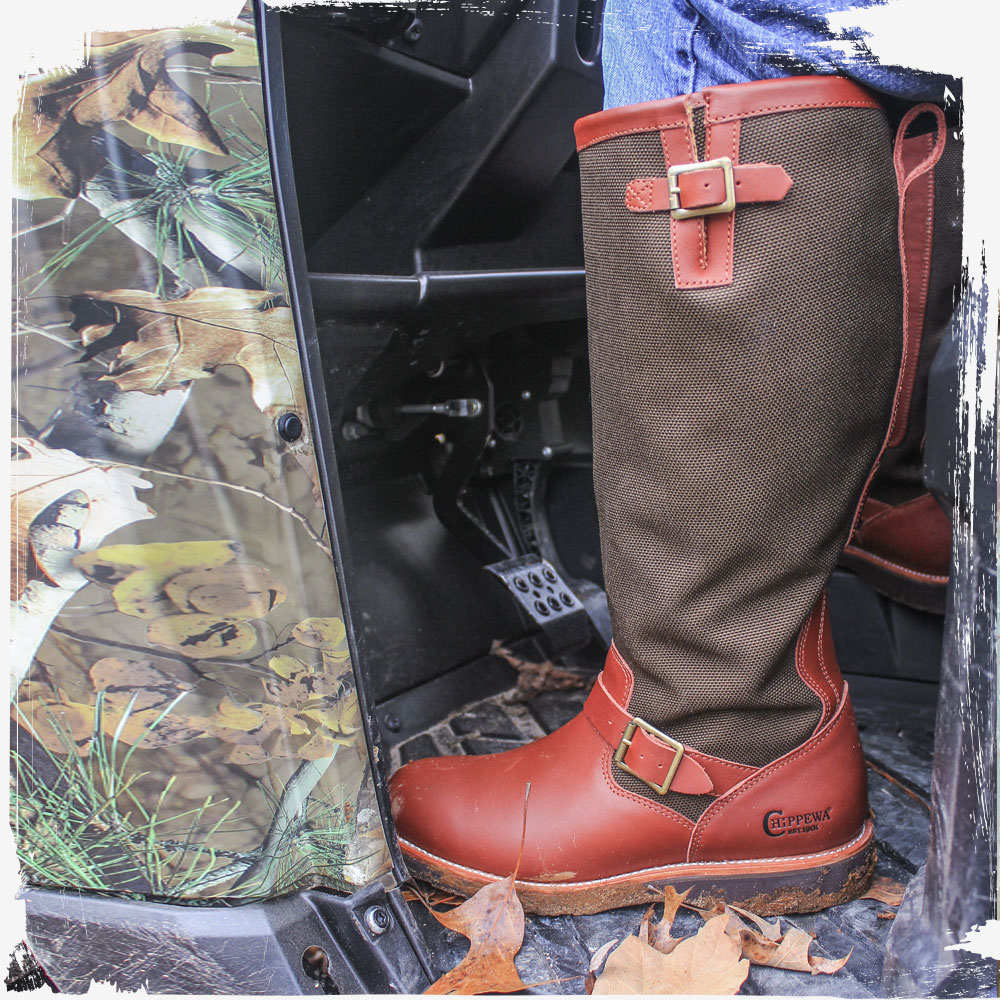 A Man wearing the Descaro 17" Snake Boot in Oro Russett (brown) while sitting on an ATV.