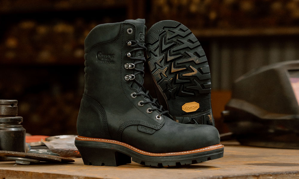 A pair of the Thunderstruck 9" Waterproof Nano Comp Toe Logger in black on a work bench.