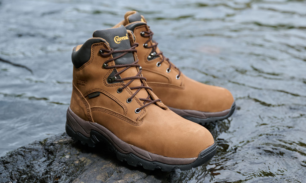 The Graeme 6" Waterproof Comp Toe Hiker in Brown sitting on a rock in a river.